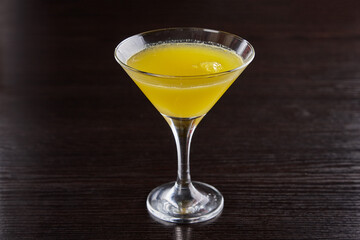 Alcoholic drinks at the bar. Bartender's hands in the process of making drinks.