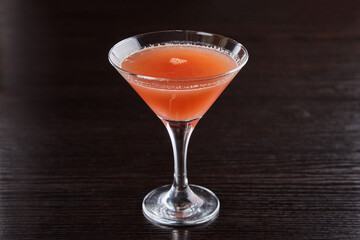 Alcoholic drinks at the bar. Bartender's hands in the process of making drinks.