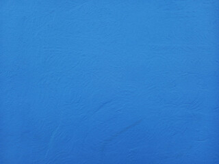 Blue painted cement background. Rough blue wall. Construction and Architecture. Full frame of Blue plaster for copy space.