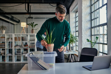 Businessman unpack box with office supplies