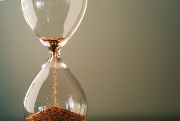 Hourglass measuring the passing time in a countdown to a deadline