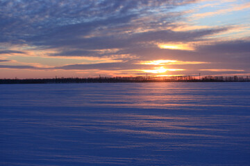 Reflection of sunlight from the snow at sunset on a winter evening