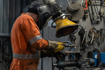 A welder at work in his workshop.	
