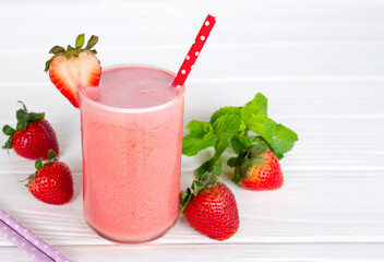 Strawberry yogurt fruit juice smoothie pink colorful fruit juice milkshake blend beverage healthy high protein the taste yummy In glass drink episode morning on white wood background.