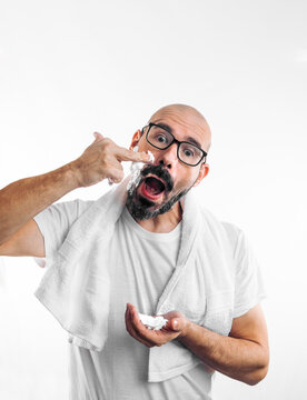 ald 40 year old man with glasses applying shaving foam