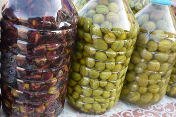Large pickled olives in a large jar.