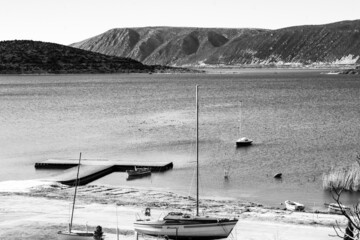 Black and white shot of Vegoritida lake in Pella Greece  in the background the mount Voras with a bit of snow 