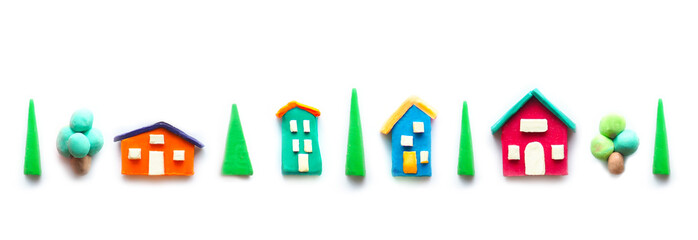 village houses made of multi-colored plasticine and trees in a row like a street..