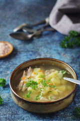 A bowl with chicken soup with pasta