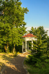 Beautiful gazebo, under a large oak, sunny summer day.