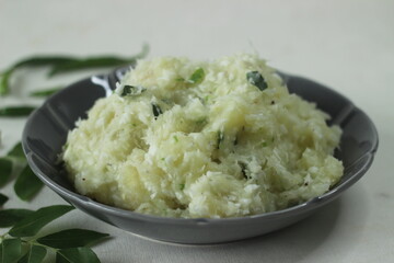 Smashed tapioca with green chilies and shallots. Popular dish of Kerala commonly called Kappa vevichathu