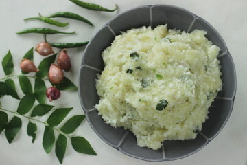 Smashed tapioca with green chilies and shallots. Popular dish of Kerala commonly called Kappa vevichathu