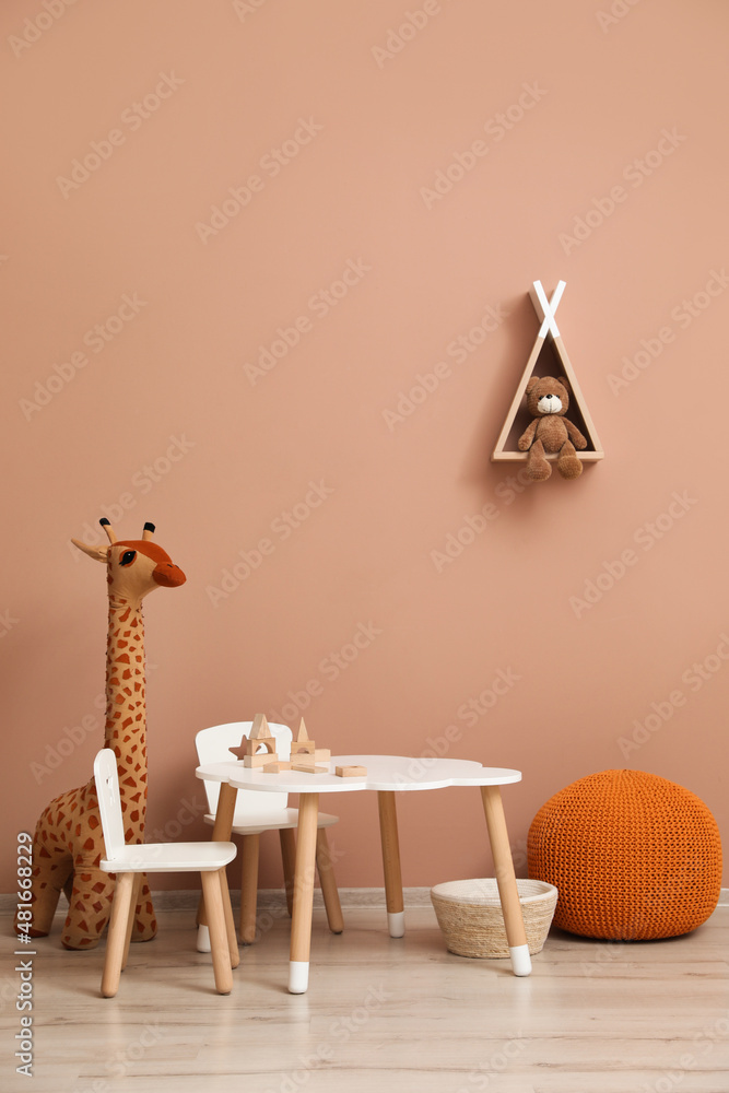 Wall mural Cute child room interior with furniture, toys and wigwam shaped shelf on pink wall - Wall murals