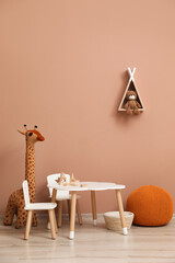 Cute child room interior with furniture, toys and wigwam shaped shelf on pink wall © New Africa