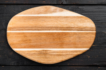 Empty vintage cutting board, on black wooden table background, top view flat lay , with copy space for text or your product