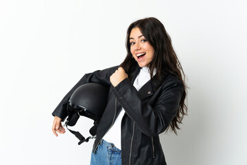 Woman holding a motorcycle helmet isolated on white background celebrating a victory