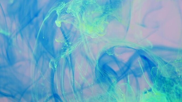 Spreading Of Blue, Green Paint In A Liquid Pink Space.