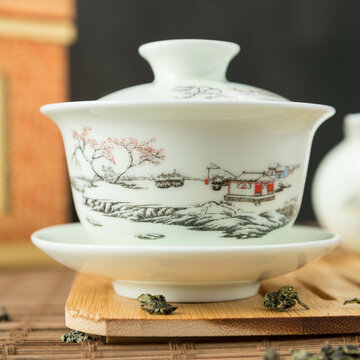 Gaivan and chahay with green tea  
 and tea brew on a brown background. Tea ceremony.  Traditional chinese tea utensils. 