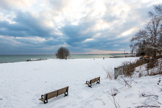 An Almost Empty Snowy  Off Leash Dog Park On The Shore Of Lake Ontario In Winter Shot In Late Afternoon.