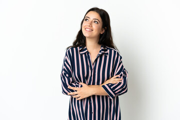 Young caucasian woman over isolated background thinking an idea while looking up