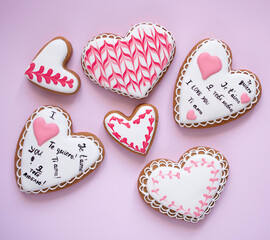 six gingerbread hearts on pink background, love and romantic concept 