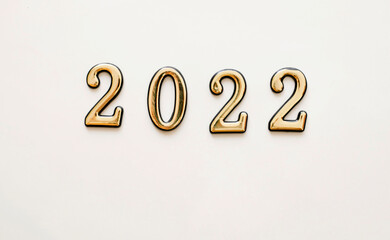 New Year and Christmas white background with golden numbers 2022. New year card decoration concept, top view with place for text.