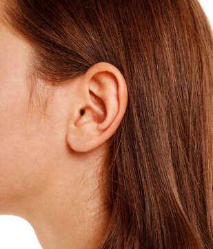 Close up human woman's ear over white background