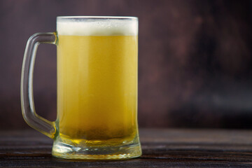 a large mug of cold light beer on a dark background. St.Patrick 's Day