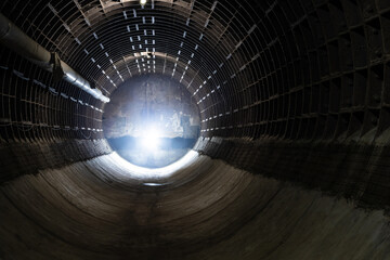 Light at the end of a long underground tunnel. Smoke and light. A beautiful tunnel in an abandoned...