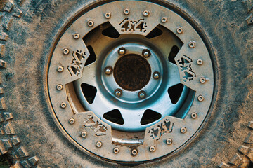 Close-up of a tire with a disc on a 4x4 four-wheel drive car. Wheel of an off-road car splattered with mud. The concept of adventure, travel or rally sports
