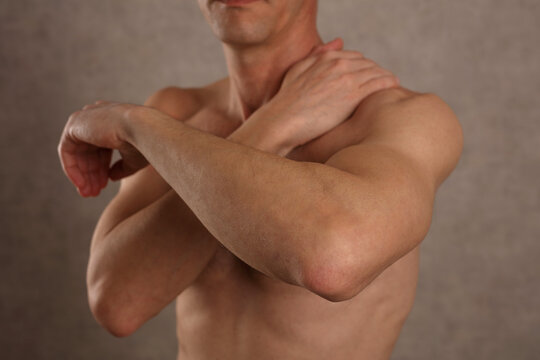 Man suffering from upper back and shoulder. Chiropractic concept. Sport exercising injury