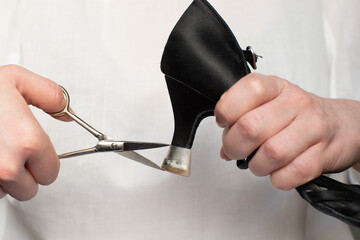 A woman's hand holds scissors and devices for protecting dance shoes from the heel. Instructions on...