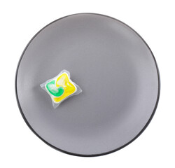 Grey plate with dishwasher detergent pod on white background, top view