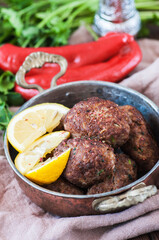 Fried minced meat kofta or kebabs served with vegetable saladf in a bowl. Close up. Middle eastern food concept.