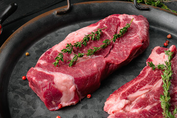 Chuck roll steak, on black wooden table background