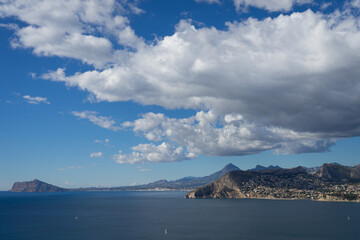 beautiful view of the blue mediterranean sea and scenic clouds near the coast