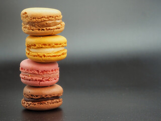 French pastries. Macaroons isolated on black background.