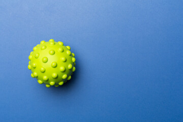 Green spiky ball toy for pet on color background