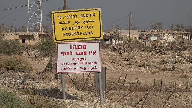 Warning sign in Hebrew, English and Arabic in Ein Gedi, along the Dead Sea coast. The sudden creation of sinkholes forced the Israeli government to close the town.
