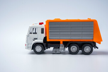 A toy garbage truck with an orange body on a white background.
