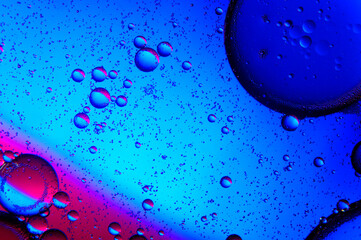 abstract background. drops of oil on water, blue and red. macro