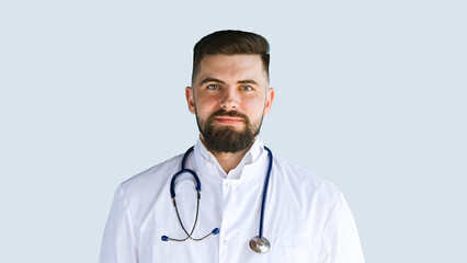 Healthcare, medicine concept: Portrait handsome doctor with stethoscope isolated over grey color background