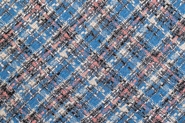 Blue checkered fabric with colored threads. Scottish wool. Fabric for a plaid coat and suit. Close-up. Background