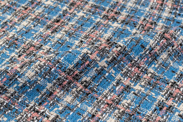 Blue checkered fabric with colored threads. Scottish wool. Fabric for a plaid coat and suit. Close-up. Background