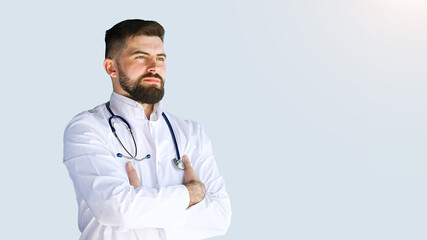 Healthcare, medicine concept: Portrait handsome doctor with stethoscope isolated over grey color background