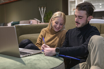 Girl and boy typing on computers in the living room. Remote working concept