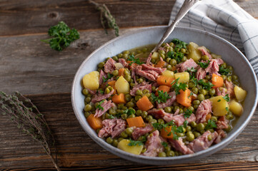 Meaty pea stew on wooden table