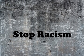 Stop racism logo. Calligraphic lettering isolated on gray background with scratches.