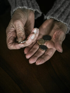 Pensioner counting money into her hands