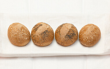 Gluten-free buns on white textile background